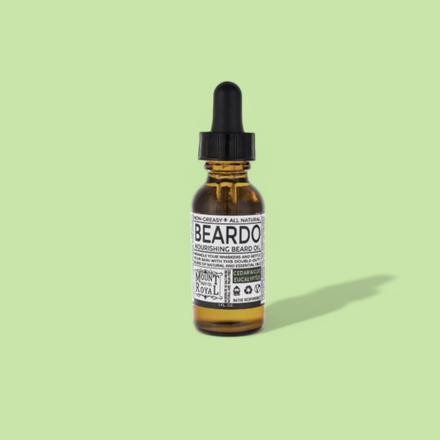 A bottle of Cedarwood & Eucalyptus Beard Oil with natural ingredients, including eucalyptus leaves and cedarwood.