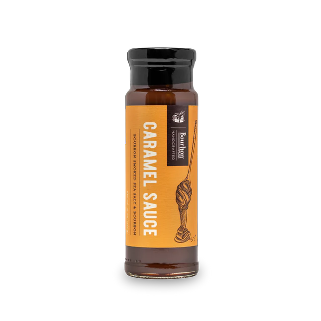 Jar of caramel sauce with bourbon and smoked sea salt – rich, thick dessert topping for gifting or indulgence.