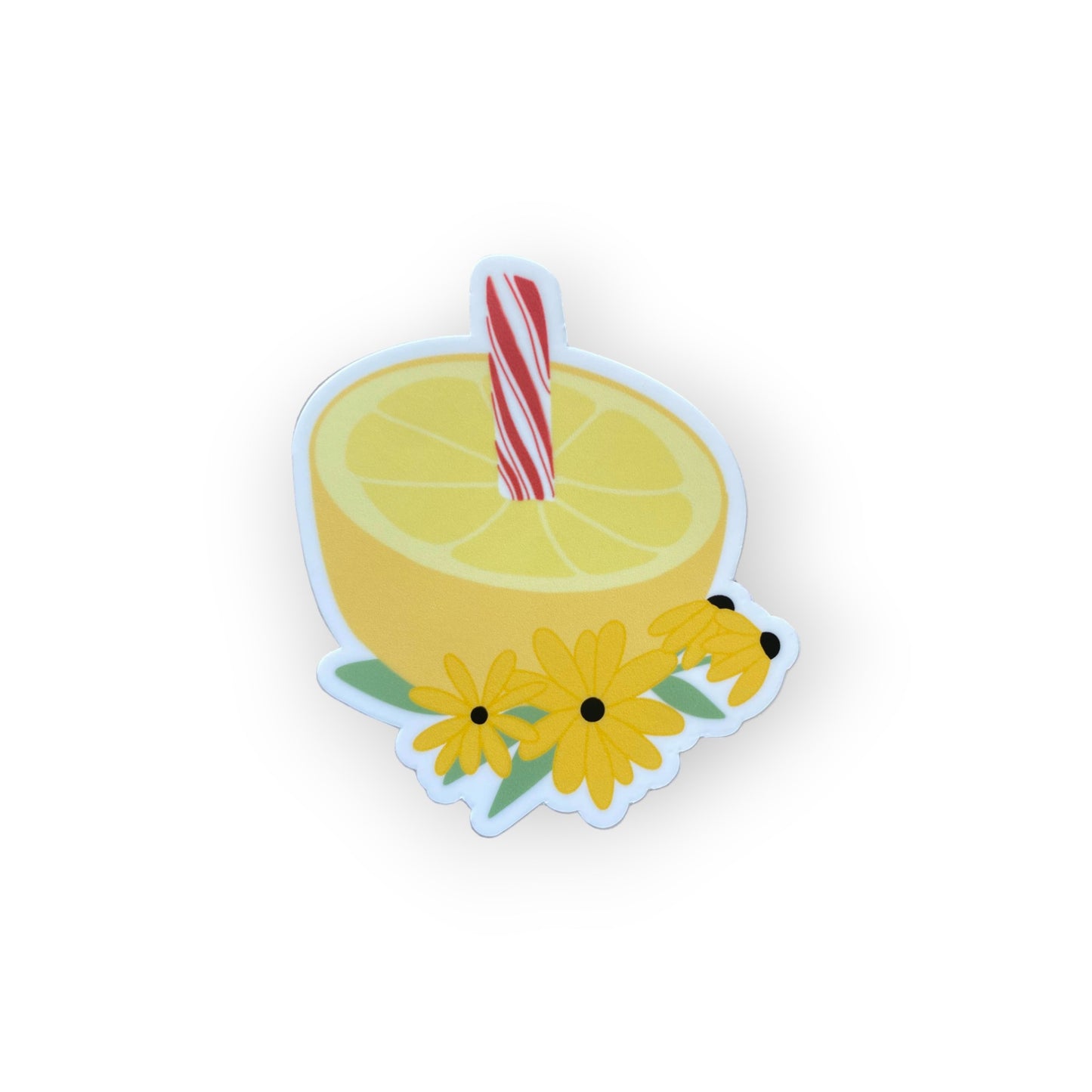 Picture of a sticker with half of a lemon and a peppermint sticking out of it, 3 black eyed susans are at the base.