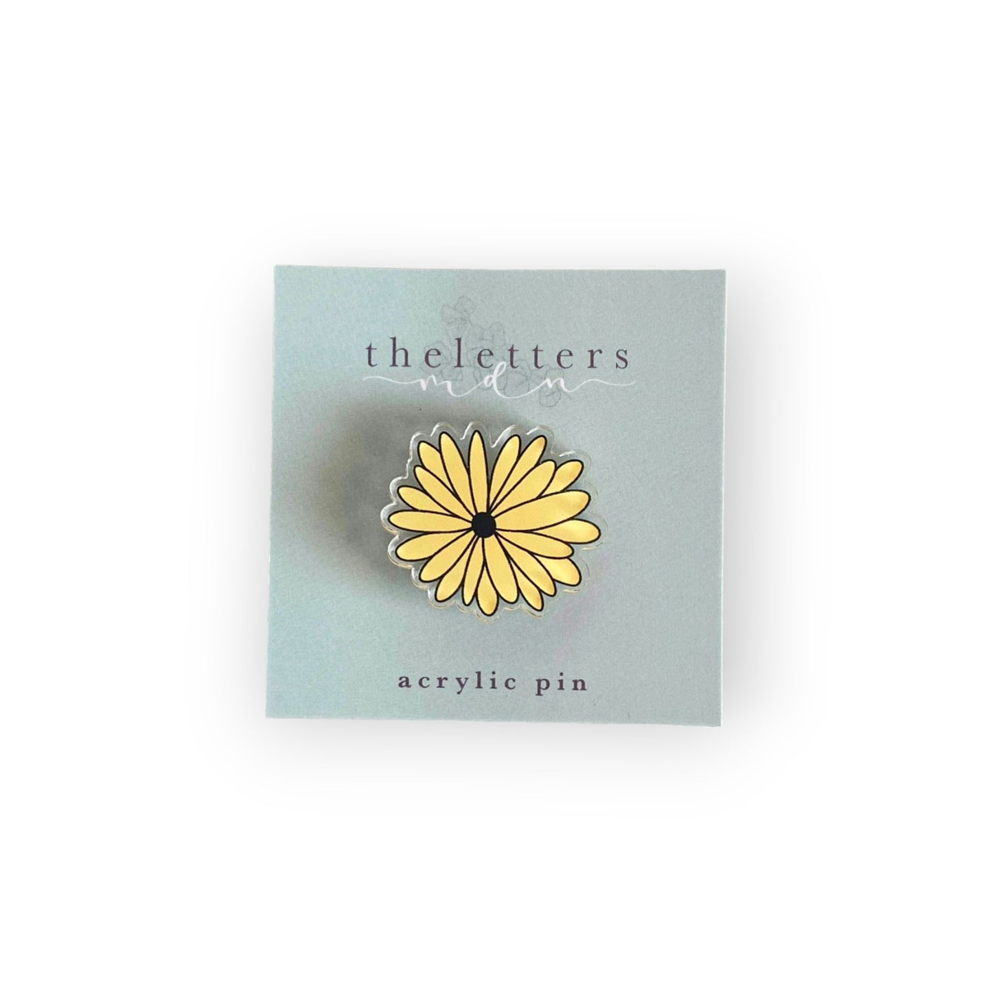 acrylic pin image of a black eyed Susan flower on cardstock