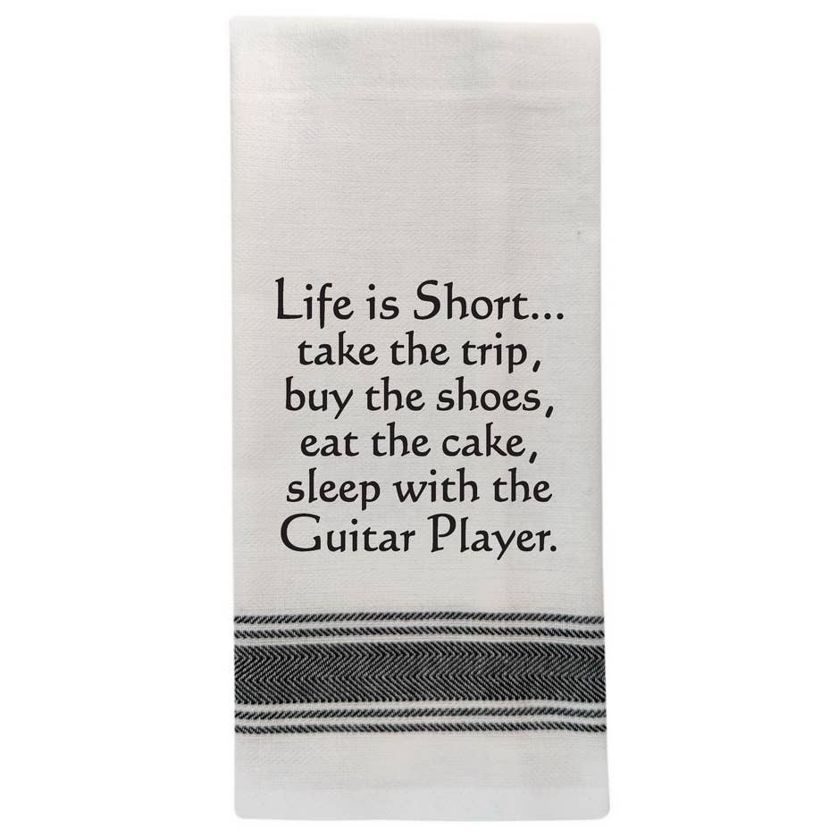 Wild Hare Designs white cotton kitchen towel with black text reading “Life is short. Take the trip. Buy the shoes. Eat the cake.” Funny absorbent tea towel gift.