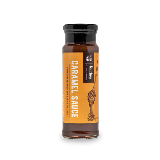 Jar of caramel sauce with bourbon and smoked sea salt – rich, thick dessert topping for gifting or indulgence.
