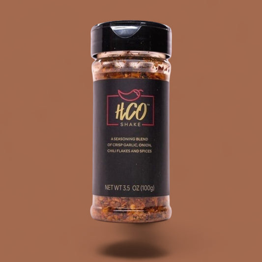 HCO Shake – garlic and chili crunch seasoning blend in clear shaker bottle.

