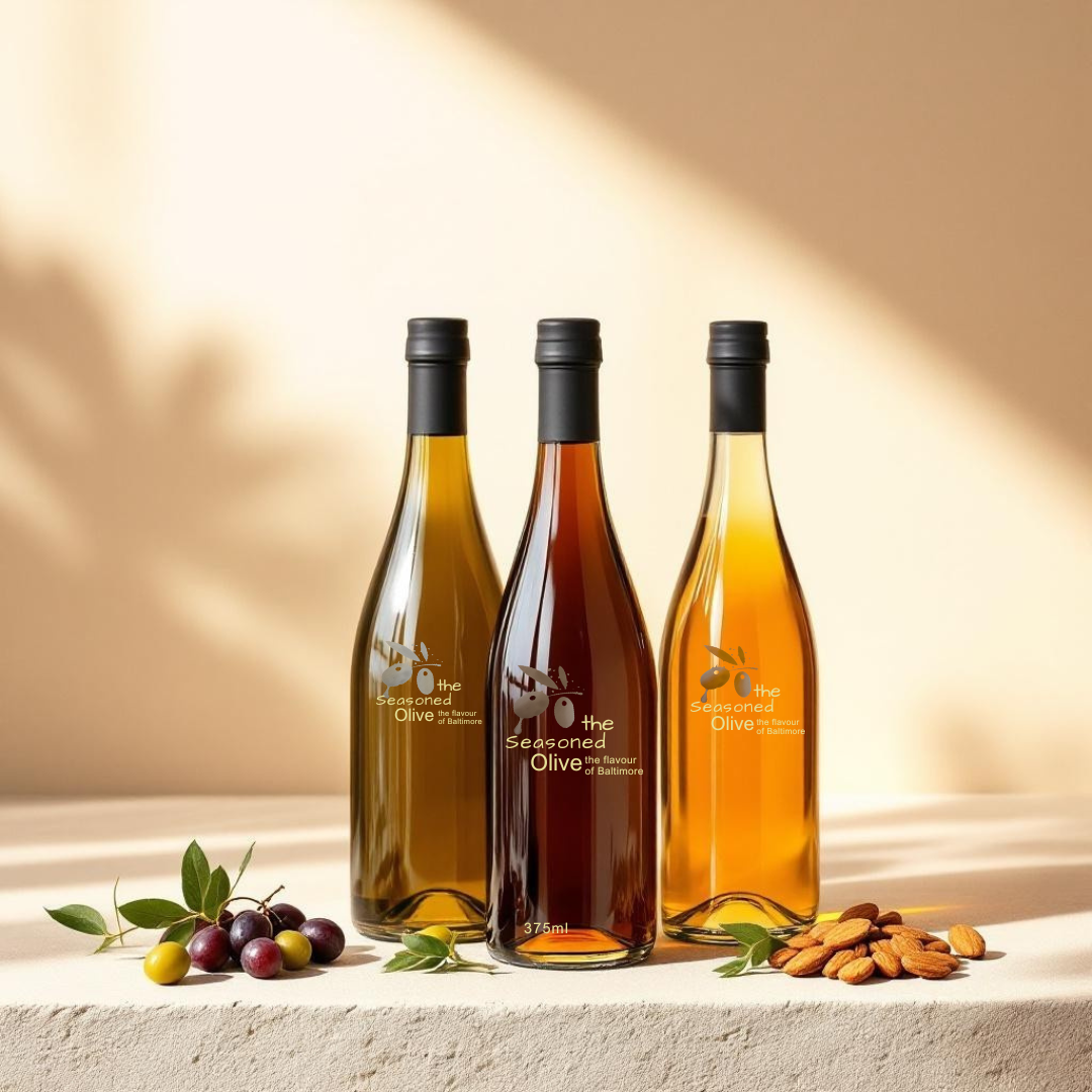 The Balance Trio featuring sherry vinegar, traditional balsamic vinegar, and arbequina olive oil styled in a clean Mediterranean kitchen setting