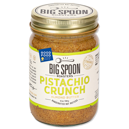 Jar of Big Spoon Roasters Pistachio Crunch Almond Butter with a Good Food Award badge on a white background