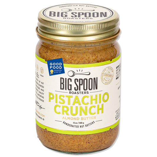 Jar of Big Spoon Roasters Pistachio Crunch Almond Butter with a Good Food Award badge on a white background