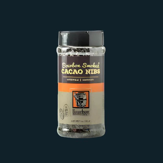 Bottle of bourbon smoked cacao nibs on a black background
