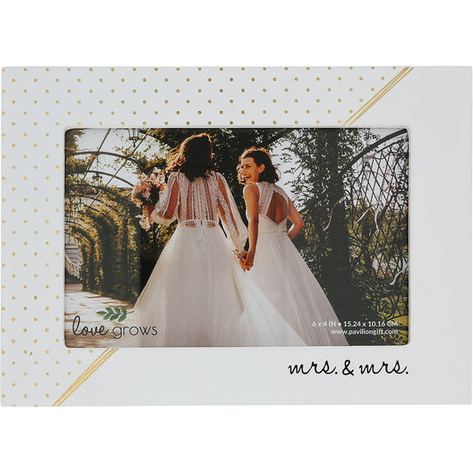 A 7.5" x 5.5" rustic whitewashed MDF photo frame with gold polka dots, metallic gold draped accents, and the sentiment "Mrs. & Mrs." Holds a 6" x 4" horizontal photo and includes a sturdy easel back. Ideal for gifting to newlyweds or celebrating anniversaries.