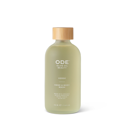 A pump bottle of ODE Olive Oil Beauty Hand & Body Wash with a beige cap and a label that includes the product name and the scent 'Verde'.