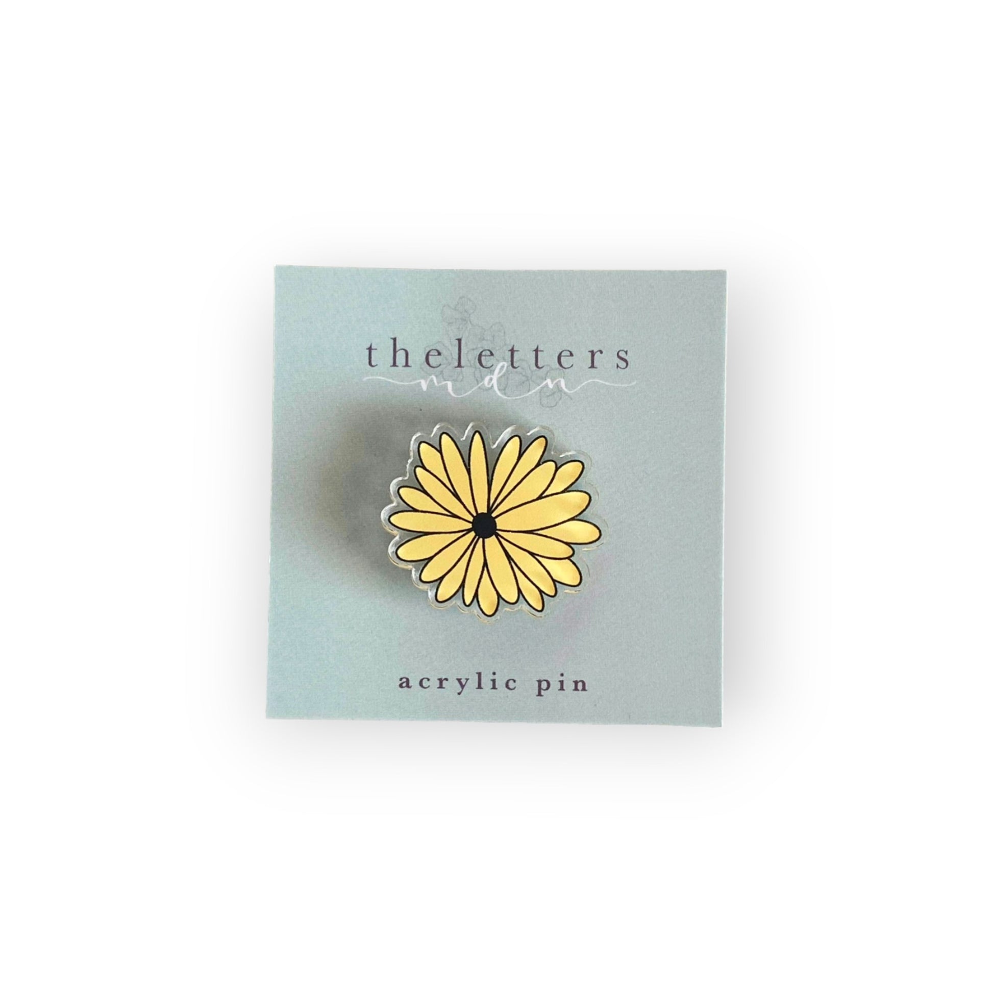 acrylic pin image of a black eyed Susan flower on cardstock