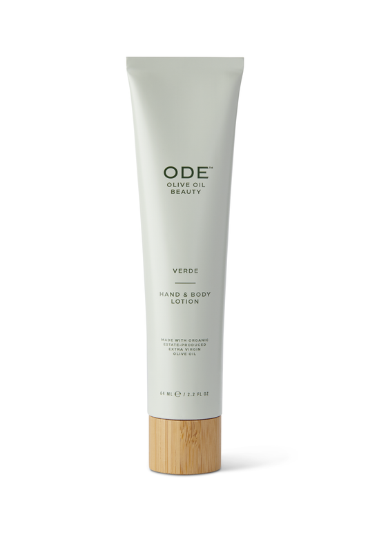 Tube of McEvoy Ranch - ODE Olive Oil Beauty Hand & Body Lotion in Verde, with a white body and green labeling, including a wooden band at the bottom.