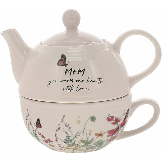 A beautiful Tea for One set featuring a 14.5 oz teapot with a pale pink lid and a 10 oz ribbed-texture cup, adorned with a floral design and the sentiment "Mom." Perfect for gifting to mothers on special occasions.