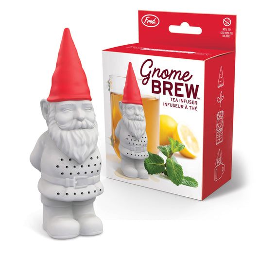 Gnome-shaped tea infuser with red hat next to its packaging on a white background